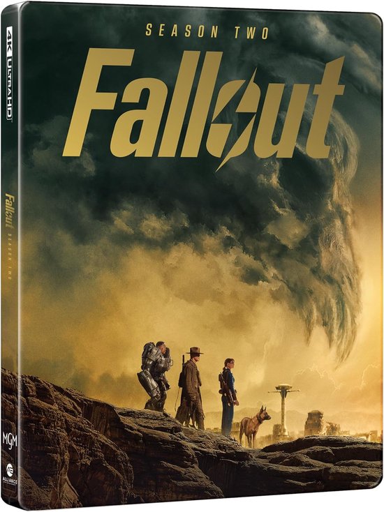 Steelbook intitulé 'Fallout Season Two'. Montre trois personnages et un chien regardant un paysage désertique sous un ciel menaçant.