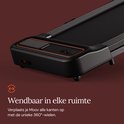 Zwarte loopband met oranje accenten, inklapbaar en wendbaar dankzij 360° wielen.