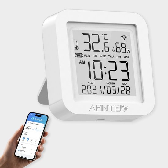 Witte digitale thermometer met tijd, datum, temperatuur en luchtvochtigheid, met smartphone.