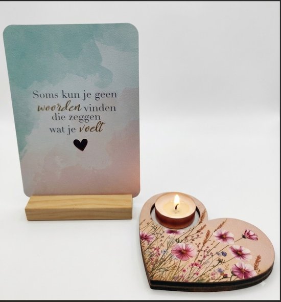 Gouden hartvormige kandelaar met bloemenprint, met een brandende kaars. Naast een kaart met de tekst 'Soms kun je geen woorden vinden die zeggen wat je voelt'.
