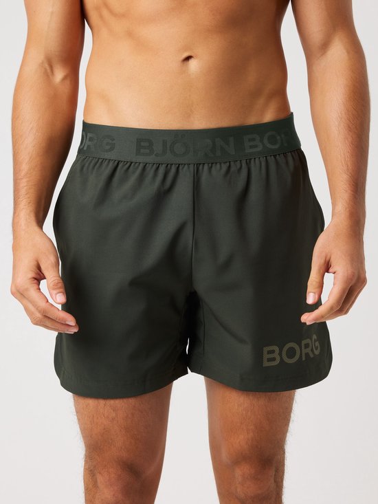 Short de sport vert foncé pour homme avec l'inscription "BJÖRN BORG" sur la jambe et une ceinture élastique.