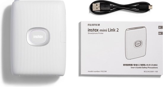 Witte Instax Mini Link 2 printer, met aan de zijkant een USB-poort en de aan/uit-knop. De printer heeft een geribbeld oppervlak.