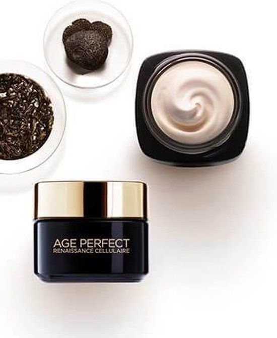 Een pot Age Perfect Cell Renaissance crème, een open pot met de crème en een gouden deksel. Ook een tros zwarte truffels en zwarte thee.