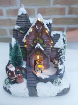 Village de Noël, maison avec Père Noël et renne en mouvement, lumières et musique
