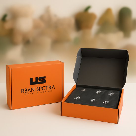 Oranje RBAN SPCTRA verpakking, deels opengeklapt met zwart papier erin.