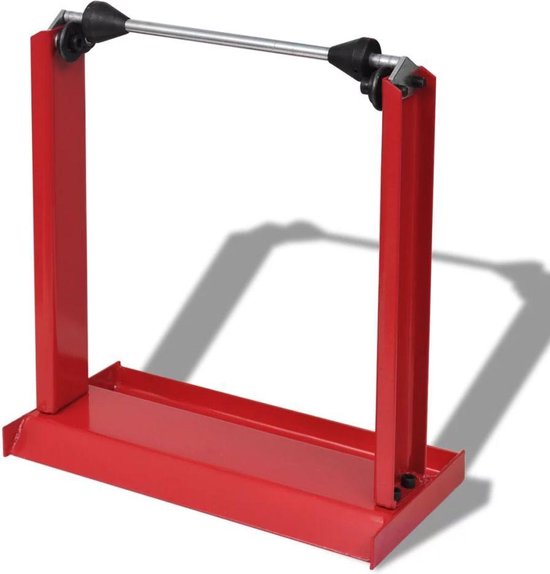 Équilibreur de roue rouge avec axe métallique et cônes noirs.