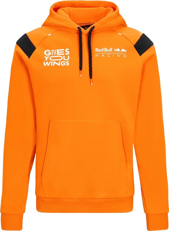 Oranje hoodie met 'GIVES YOU WINGS' opdruk op de linkerborst en Red Bull Racing logo op de rechterborst. Zwarte details op de schouders.