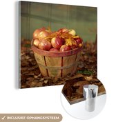 MuchoWow® Glasschilderij 90x90 cm - Schilderij acrylglas - Een mand van appels in de herfst - Foto op glas - Schilderijen