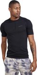 Man in zwart Craft sportshirt met korte mouwen en grijze shorts met tie-dye patroon. Gestructureerde stof op schouders en mouwen.