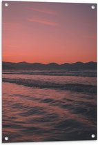 WallClassics - Tuinposter – Golvende Zee met Oranje Paarse Lucht - 60x90 cm Foto op Tuinposter (wanddecoratie voor buiten en binnen)