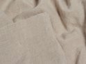 Gevouwen beige linnen stof, close-up.