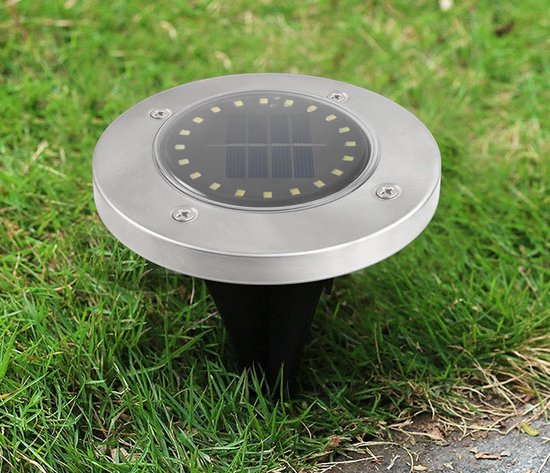Stalen zonnegrondspot met 20 LED's en zonnepaneel, geplaatst in het gras.