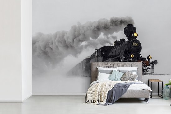 Behang - Fotobehang Stoomlocomotief in de sneeuw - liggend - Breedte 420 cm x hoogte 280 cm