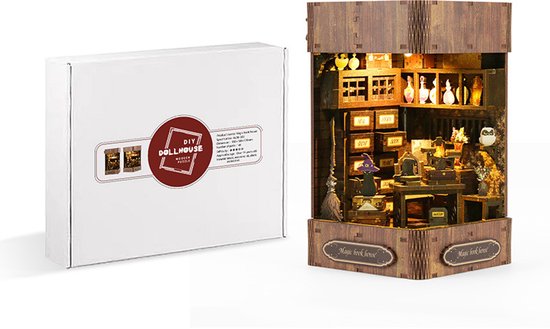 Een doe-het-zelf miniatuur huisje 'Magic Book House' naast de verpakking.