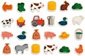 24 houten magneten met boerderijdieren en -voertuigen, waaronder koeien, varkens, een tractor en meer.
