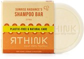 Een doosje en een rond zeepblok met de tekst 'Sunrise Radiance's Shampoo Bar Citrus'.