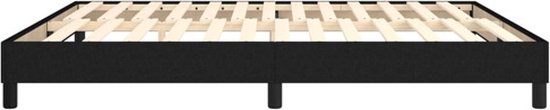 Zwart boxspringbed met houten lattenbodem en vier zwarte poten, detailopname.