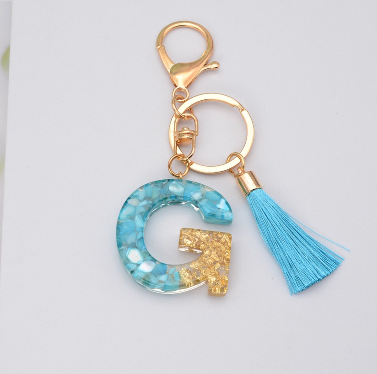Sleutelhangers of voor je tas van A tot Z - met een pompon of kwastje - met letter - mooi design - handgemaakt - sleutelhangers - design - mode - goud - zwart - blauw - roze- rood