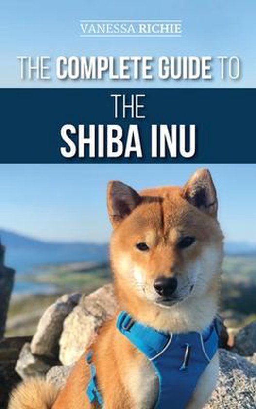 De complete gids voor de Shiba Inu, met op de voorkant een Shiba Inu met blauw harnas.