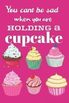 You can't be sad when you are holding a cupcake