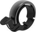 Zwarte Knog Oi fietsbel met compact aluminium design en zilveren accents.