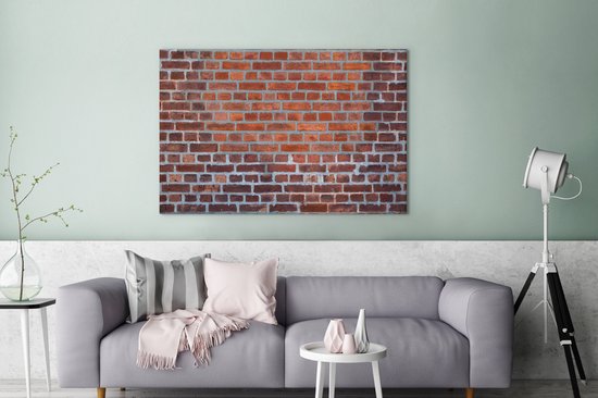 Gros plan d'un mur de brique qui a été restauré toile 2cm 140x90 cm - Tirage photo sur toile (Décoration murale salon / chambre)