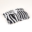 Opgevouwen zebra-print deken met mouwen, samengebonden met een wit lint en strik.