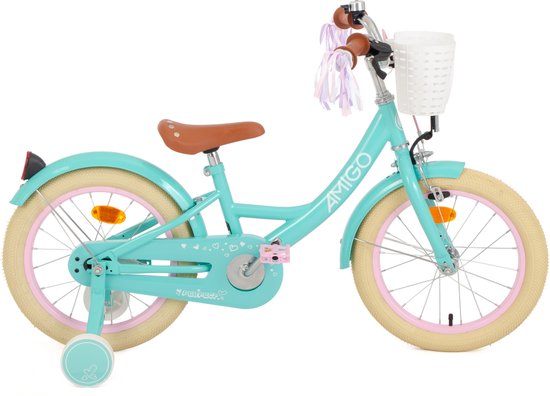 Vélo d'enfant turquoise avec selle marron, panier blanc, rubans violets et roulettes. L'inscription "AMIGO" est visible sur le cadre.