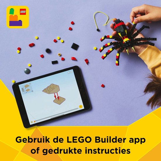 Tablet met LEGO bouwinstructies naast een zwarte, rode en gele LEGO spin.