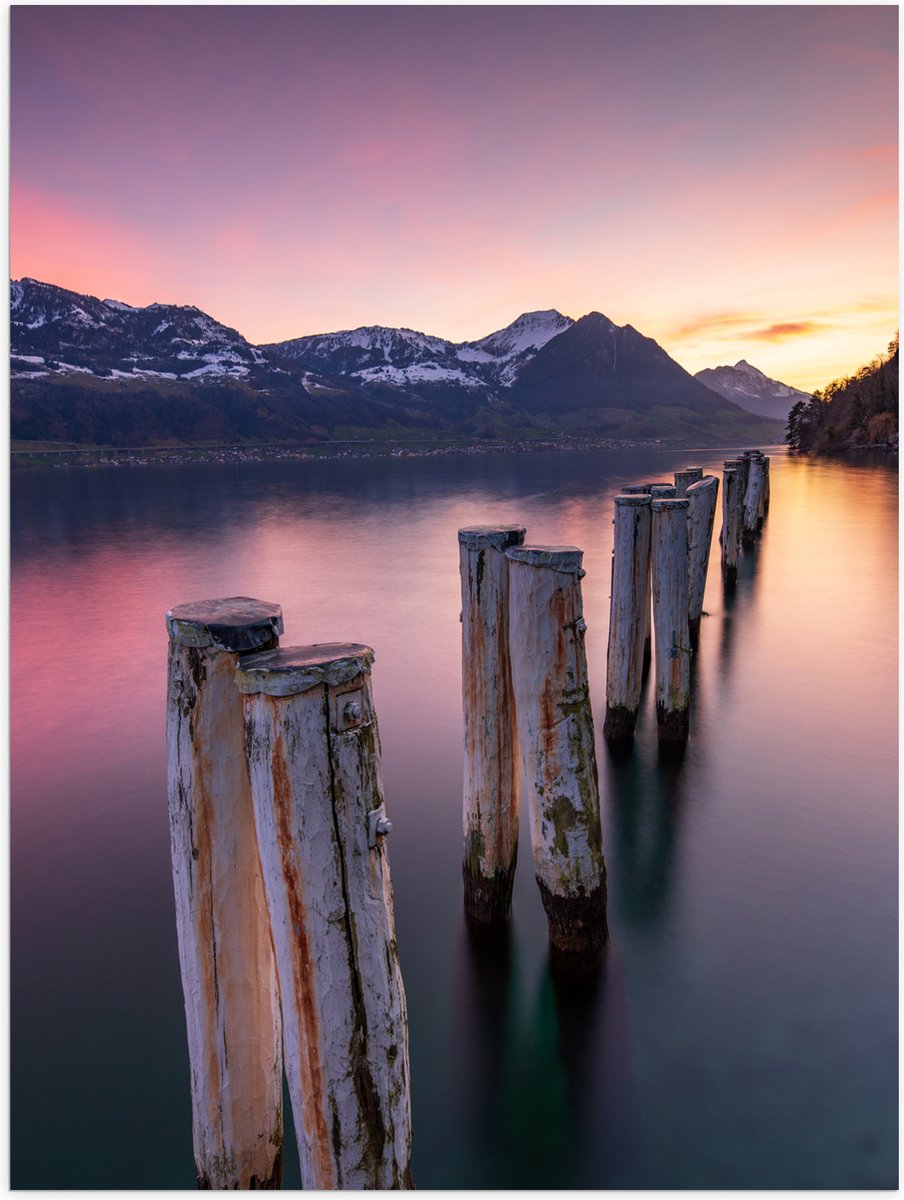 Poster (Mat) - Houten Palen in het Meer van Berggebied tijdens Zonsondergang met Paarse Gl