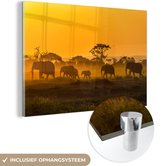 MuchoWow® Glasschilderij 120x80 cm - Schilderij acrylglas - Kudde olifanten bij zonsopkomst - Foto op glas - Schilderijen