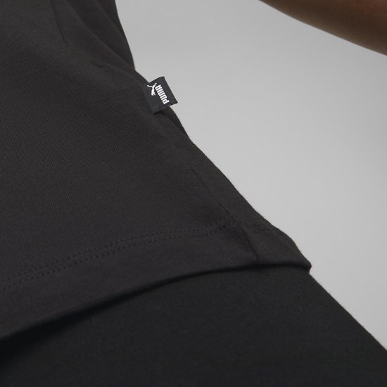 Detail van de zoom van een zwart T-shirt met PUMA label.