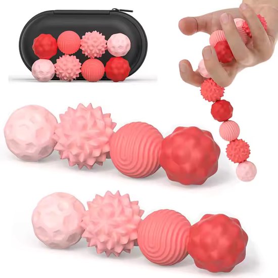 Acht roze en rode magnetische focusballen met verschillende texturen, waaronder stekelig en gegolfd, in een zwart etui.