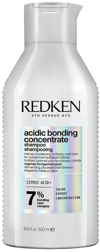 Bouteille de shampooing Redken Acidic Bonding Concentrate de 500 ml avec un corps blanc et des accents argentés et violets.