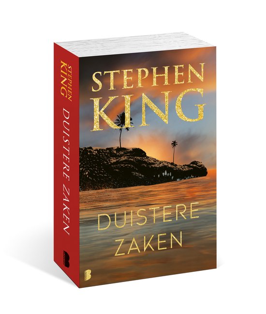 Boek "Duistere Zaken" van Stephen King met een gouden glitterende titel, met op de voorkant een eiland met palmbomen bij zonsondergang.