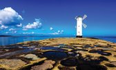 Fotobehang - Vlies Behang - Windmolen op Rotsachtige Kust aan Zee - 416 x 254 cm