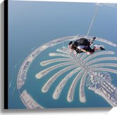 Canvas - Parachutespringer boven de Palm van Dubai - 60x60 cm Foto op Canvas Schilderij (Wanddecoratie op Canvas)