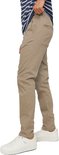 Man met gestreept blauw-wit T-shirt en beige chino broek, de zijkant zichtbaar.
