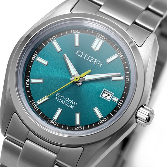 Close-up van een zilverkleurig Citizen Eco-Drive Titanium horloge met blauwgroene wijzerplaat.