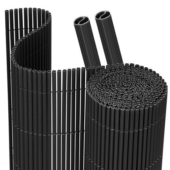 Twee opgerolde zwarte PVC schermen en twee losse PVC palen met ribbels.