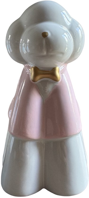 Wit keramieken hondenbeeldje met roze jasje en gouden strik, vooraanzicht.