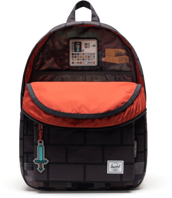 Open rugzak met zwart baksteenpatroon, oranje voering en een Minecraft-print van items.
