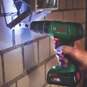 Bosch EasyImpact 18V-40 boort in een stenen muur, verlichting schijnt op het werkgebied.