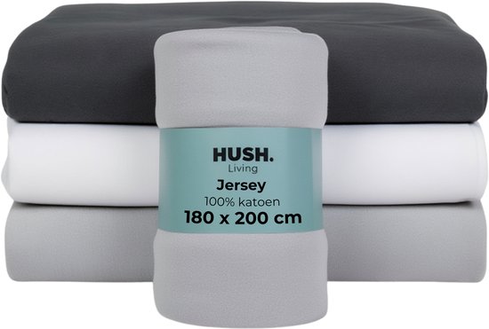 Drap-housse empilé de 180x200 cm en anthracite, blanc et gris clair. Emballé avec une étiquette HUSH. Living.