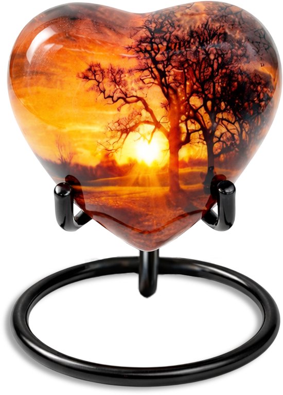 Hartvormige urn met zonsopkomst en boom, op zwarte standaard.