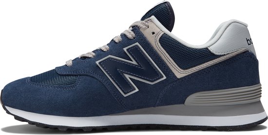 Donkerblauwe New Balance sneaker met grijze en witte accenten en een grote grijze 'N' op de zijkant.