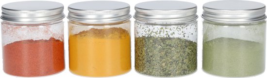 Vier glazen potjes met zilverkleurig schroefdeksel, gevuld met paprikapoeder, kurkumapoeder, groene kruiden en groen poeder.