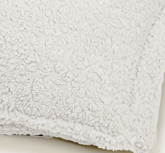 Close-up van de zachte, ecrukleurige teddy stof textuur.