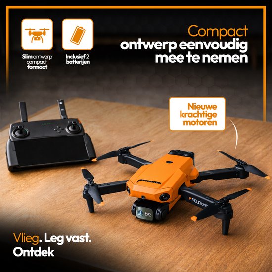 Oranje en zwarte drone met opgevouwen armen op een houten tafel. Naast de drone ligt een zwarte controller.