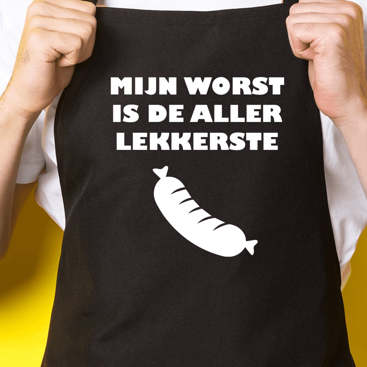 Zwart keukenschort / BBQ-schort met tekst | Mijn worst is de aller lekkerste | Katoen - One size - Verstelbaar - Wasbaar - Cadeau voor hem - Vaderdag - Gratis verzending - Cadeau voor Kerst & sinterklaas | Incl. 2 jaar garantie